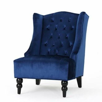 Blue velvet accent chair with tufted back and wooden legs