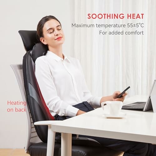 Person relaxing on heated office chair with laptop and coffee.